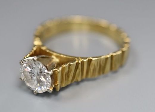 A modern textured 18ct gold and solitaire diamond ring, the stone weighing 0.90ct, size L, gross 4.1 grams,